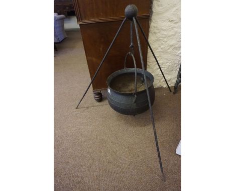 An Antique Style Iron Cauldron / Cooking Pot, Having a swing handle, approximately 50cm high, raised on an iron stand, overal