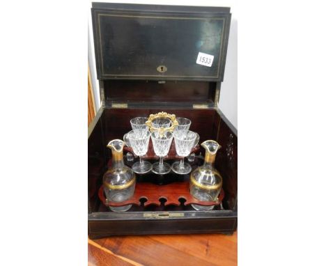 A boxed decanter set with glasses and bottles