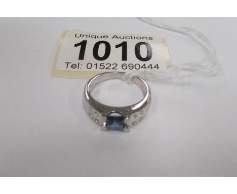 A white gold sapphire and diamond ring, size N