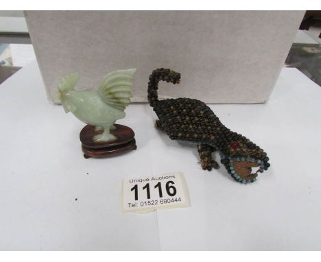 A jade cockerel and a beadwork lizard