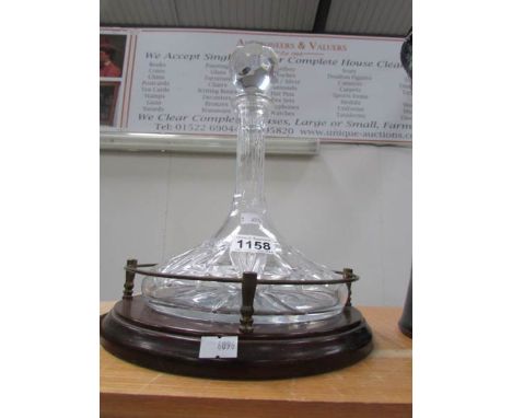A captain's ship decanter on galleried stand
