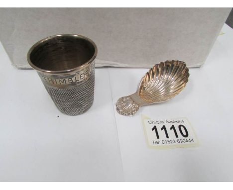 A silver caddy spoon and a silver 'Just a thimble full' spirit measure