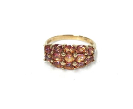 A 9ct gold ring set pink stones, stamped 375, size O