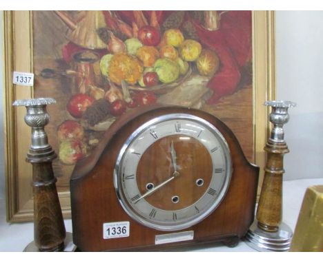 A mantel clock and a pair of wood & metal candlesticks