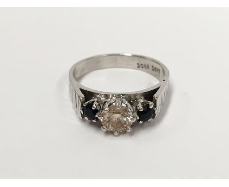 An 18 carat gold quarter carat central diamond flanked by 2 sapphires ring, size J