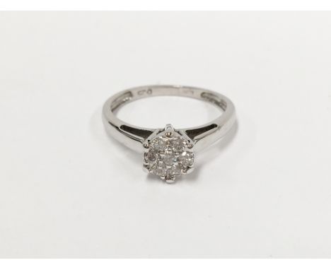 A quarter carat 7 stone diamond 18 carat white gold ring, size K half