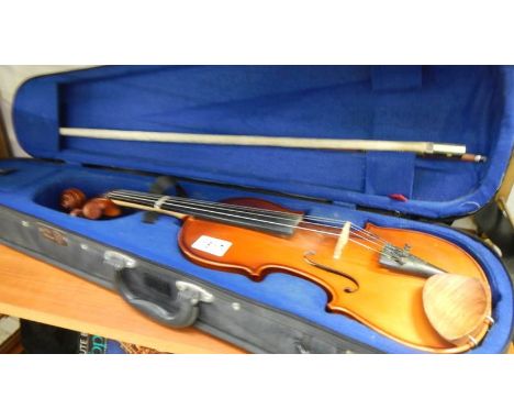 A cased violin with bow