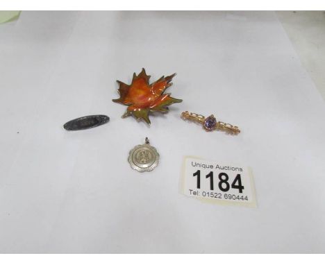 A 9ct gold brooch set amethyst, a silver 'Baby' brooch, a silver fob and a Norwegian silver and enamel maple leaf brooch