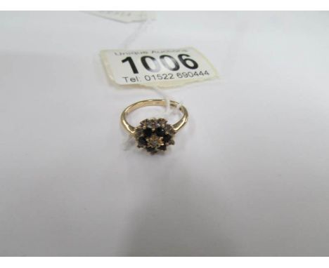 A yellow gold diamond and sapphire floral ring, size K half