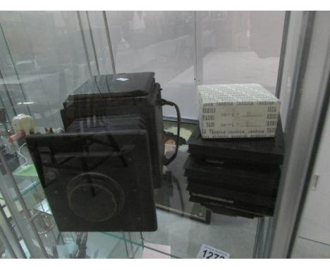 A late 19th / early 20th century plate camera with plates, slight damage to top cover