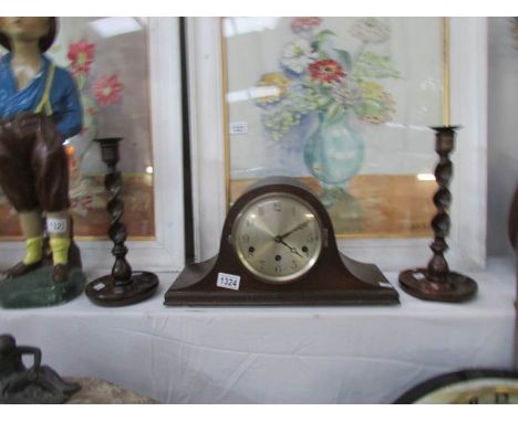 An oak mantel clock and a pair of oak barley twist candlesticks