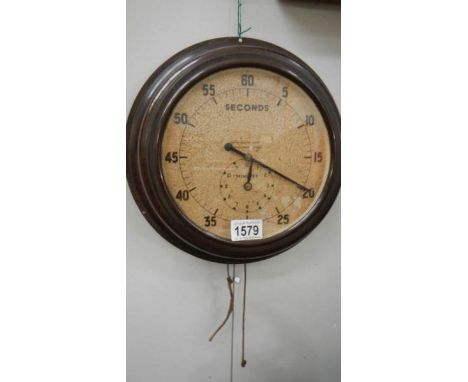 A vintage Smith's wall mounted timer clock in bakelite case