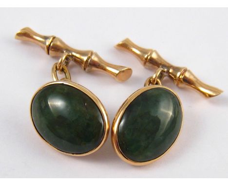 A pair of yellow metal (tests 14 carat gold) jade cufflinks of bamboo design, marked 14k and unascribed facsimile signature, 