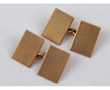 A pair of 9 carat gold cufflinks with engine turned decoration, hallmarked Birmingham 1937, 6.5 gms.
