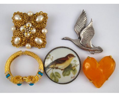 A mixed lot comprising three costume jewellery brooches and a bangle, including Givenchy, Stanley Hagler , Limoges and Cadoro