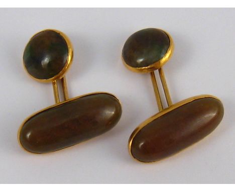 A pair of yellow metal (tests 18 carat gold) jade cufflinks, the elongated oval sections measuring approx 23mm long, 9.9 gms.