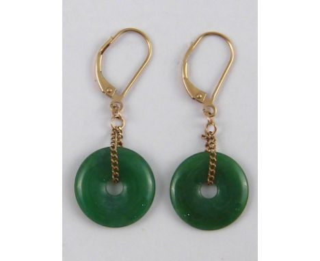 A pair of jade disc drop earrings, discs approx 15mm wide, drop approx 4cm, fittings marked 9K for 9 carat gold.

