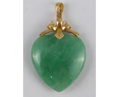 A jade heart pendant with a yellow metal (tests 14 carat gold) mount, approx 4cm drop.
