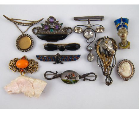 A mixed lot of good vintage brooches including a white metal (tests silver) Egyptian revival scarab with plique-a-jour enamel