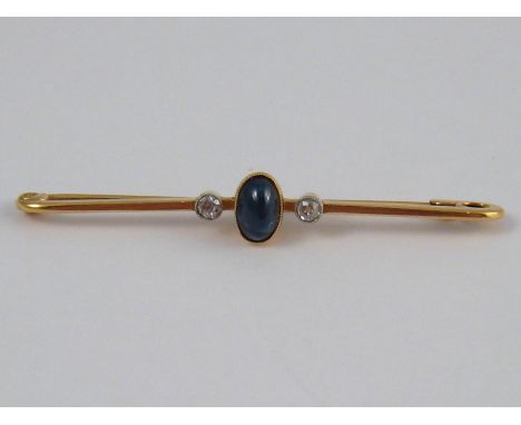 A yellow metal (tests 18 carat gold) cabochon sapphire and diamond brooch, approx 5cm long, 2.7 gms.
