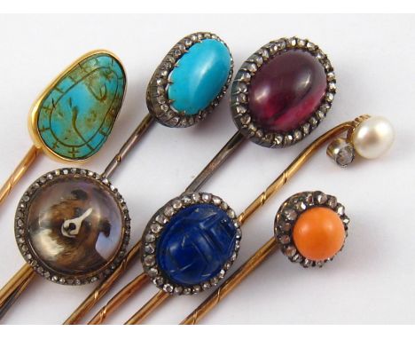 A collection of seven fine antique stick pins, five with Austro - Hungarian gold dog's head mark, being lapis lazuli carved a