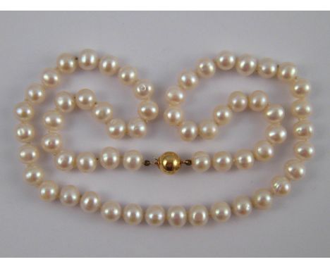A freshwater cultured pearl necklace, pearls approx 7mm diameter, necklace approx 46cm long, with yellow metal (tests 9 carat