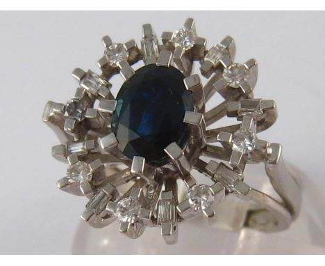 A white metal (tests 18 carat gold) sapphire and diamond ring, the sapphire measuring approx 7.5 x 5.5 mm, ring size K, 6.6 g