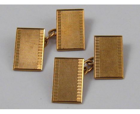 A pair of 9 carat gold cufflinks with engine turned decoration, hallmarked Birmingham 1936, 4.3 gms.
