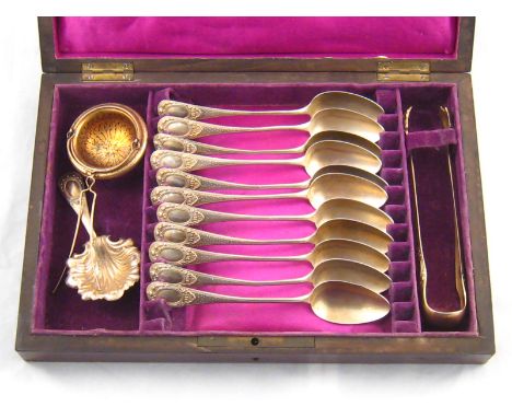 A set of eleven French 800 standard silver teaspoons, tongs, caddy spoon and pendant tea strainer in fitted rosewood case. Wt