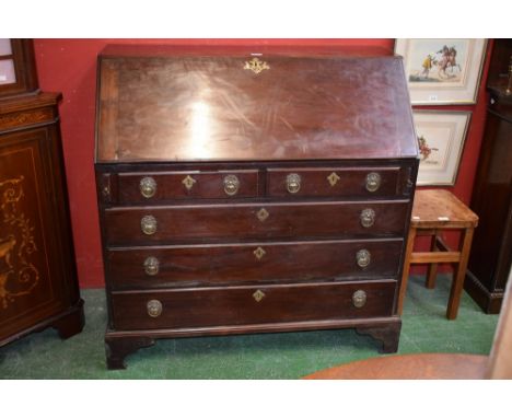 A 19th century mahogany bureau, fall front enclosing an inset writing surface, a small door, drawers and pigeon holes above t