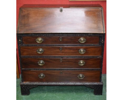 A George III mahogany bureau, fall front enclosing a cupboard, pigeon holes, small drawers, secret compartments, above four l