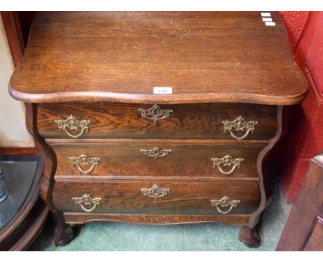 A reproduction oak bombe shaped chest/commode, of small proportions, serpentine top above three long drawers, 65.5cm high