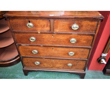 A George III oak chest of two short and three long graduated cockbeaded drawers, the top crossbanded, the upper long drawer l