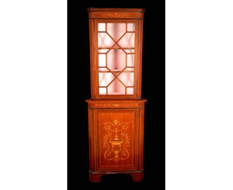 An Edwardian mahogany and marquetry floor standing corner display cabinet, outswept moulded cornice above an astragal glazed 