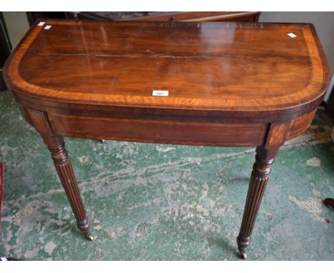 A 19th century mahogany card table, crossbanded hinged top enclosing a baize lined playing surface above a deep frieze, turne