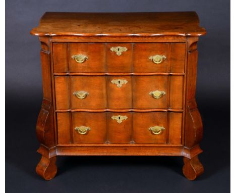 A Dutch oak shaped serpentine commode, of small proportions, three long graduated drawers, 80cm high, 86cm wide