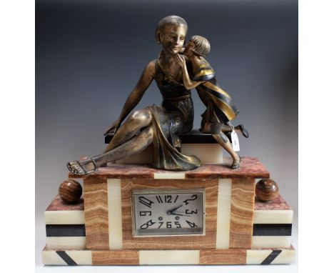 A French Art Deco style marble and onyx mantel clock, encased escapement, by J.Marty, striking on a bell, surmounted with a m