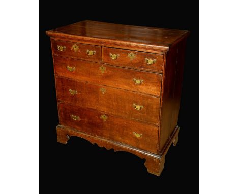 An early 18th century oak chest, rectangular top with moulded edge above two short and three graduated long drawers, brass ba