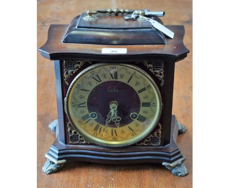 An Odo bracket style mantel clock, brass dial, twin winding holes, Roman and Arabic numerals, striking, key 