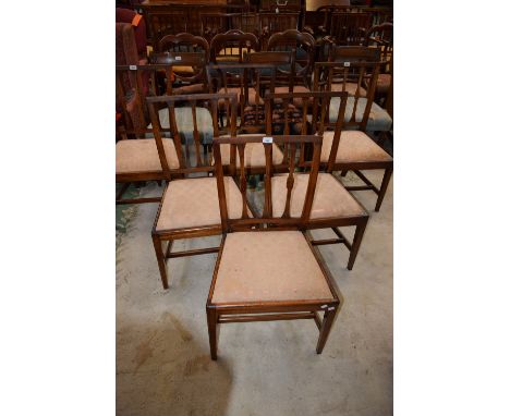 A set of six early 20th century mahogany dining side chairs, each with a curved cresting rail above shaped stick back, tapere