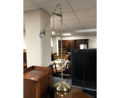 An adjustable standard reading lamp, in antique brass effect finish. 