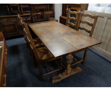 An oak refectory dining table together with a set of four rush seated ladder back dining chairs