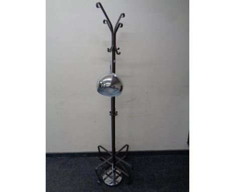 A contemporary metal hat and coat stand on four way pedestal together with a floor lamp in a chrome finish 