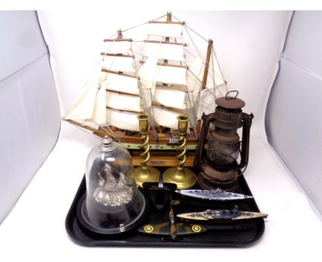A tray containing antique oil lamp, three diecast models of a spitfire, the Bismarck and HMS Hood, a model ship under dome, a
