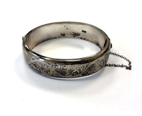 An engraved silver bangle CONDITION REPORT: 24.9g