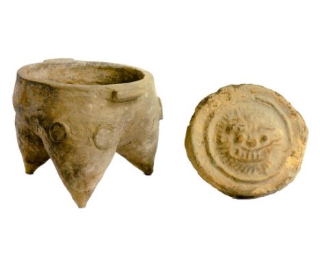 A CHINESE EARTHENWARE MAMIFORM TRIPOD JAR, LATE SHANG DYNASTY  of unglazed grey fabric, 10.5cm h and an eaves tile end, Weste