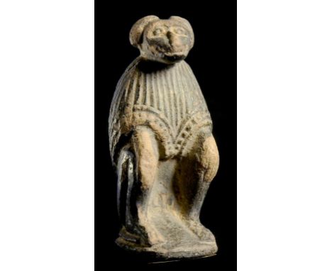 AN EGYPTIAN FAIENCE FIGURE OF THOTH, LATE PERIOD, 1070-332BC the squatting baboon in ceremonial cloak with black pigment, 8.5