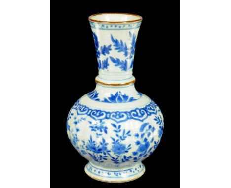 A CHINESE BLUE AND WHITE VASE, KANGXI  with lobed body and flared neck, painted with flowers, the neck cordon and rim outline