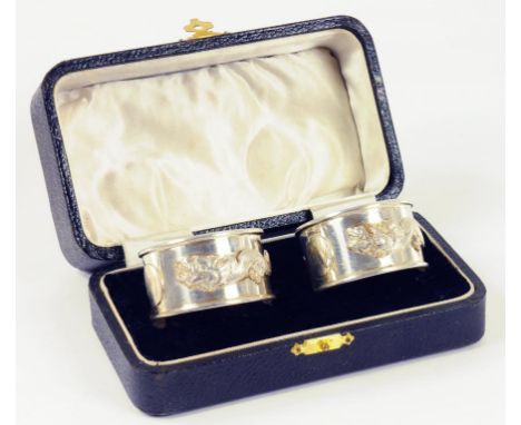 A PAIR OF CHINESE SILVER NAPKIN RINGS APPLIED WITH A DRAGON MARKED WIKE SILVER, EARLY 20TH C, CASED, 2OZS 10DWTS