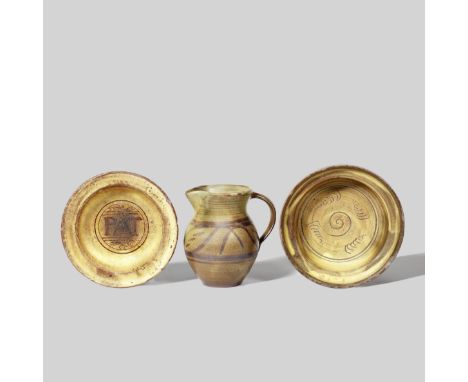 Michael Cardew, Leach Pottery and Winchcombe PotteryJug and two bowlsGlazed earthenware, incised and painted designs. Jug: 15